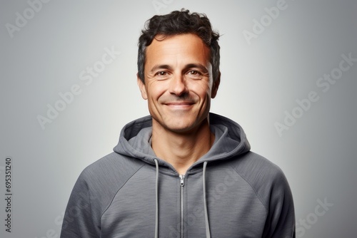 Portrait of a blissful man in his 40s wearing a zip-up fleece hoodie against a white background. AI Generation