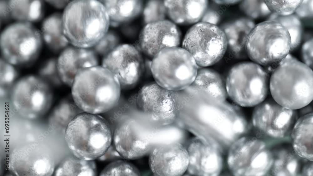 Falling and rolling silver balls on a surface with other many balls background. Jewelry silver pearl beads. Silver balls rotation Falling and rolling silver balls on a surface with other many balls background. Jewelry silver pearl beads. Silver balls rotation
