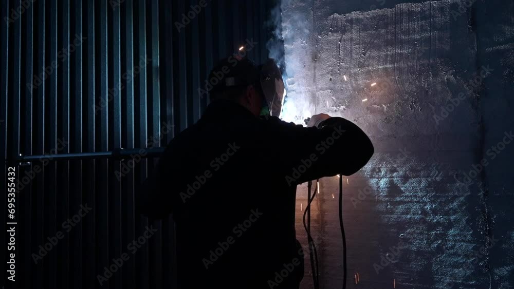 Welder Welds a metal pipe. Iron welding	