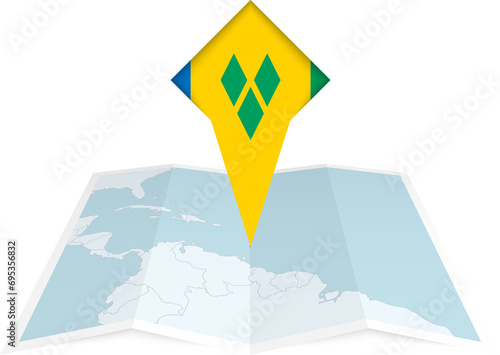 Saint Vincent and the Grenadines pin flag and map on a folded map photo