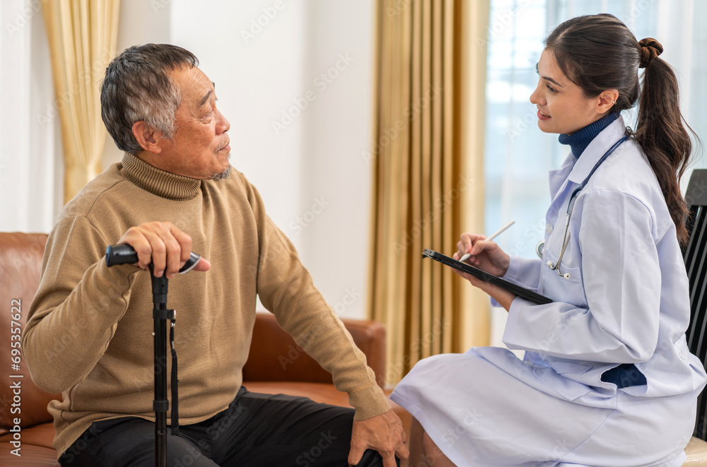 Obraz premium Portrait of smiling caring asian doctor service help support discussing and consulting taking care, caring, caregiver with senior elderly asian man at home visit.senior retirement home care