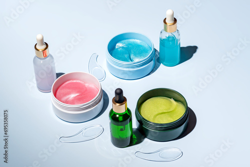 Assortment of colorful skincare cosmetics on a light background