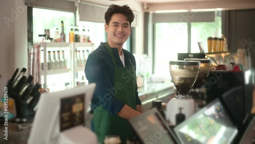 An Asian man entrepreneur or barista working in modern coffee shop , concept small business