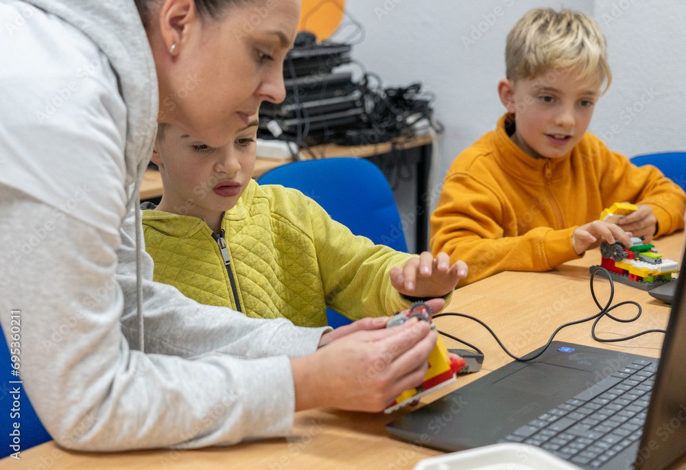 Robotics class for children with a teacher Robotics class for children with a teacher