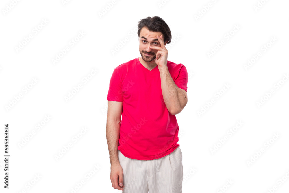 young slender brunette advertiser man dressed in a red t-shirt. corporate color concept young slender brunette advertiser man dressed in a red t-shirt. corporate color concept