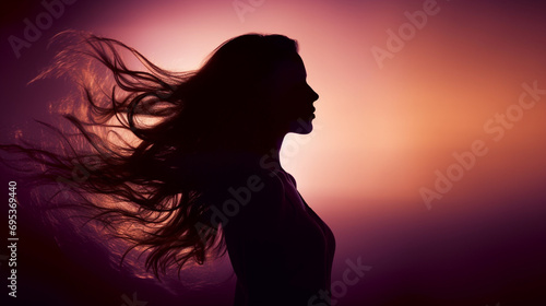A silhouette of a woman with her hair flowing, representing freedom and strength, Feminism, Women day, blurred background, with copy space