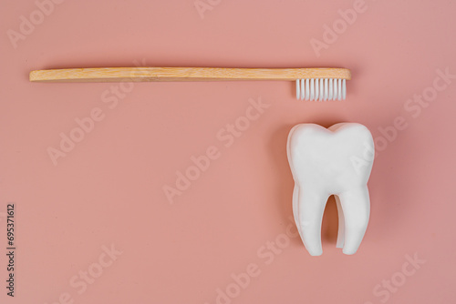 Tooth and eco tooth brushes on a beige background. Concept of dental examination of teeth, health and dental hygiene. Prevention of caries and tartar teeth. photo