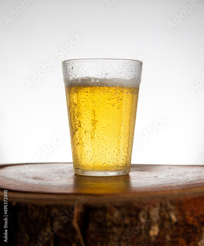 Glass of light beer on typical brazilian cup (americano long drink). photo