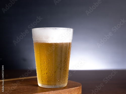 American glass with Beer on wooden table (Traditional Brazilian Cup)