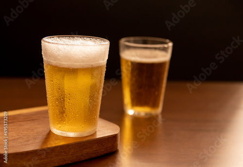 American glass with Beer on wooden table (Traditional Brazilian Cup)