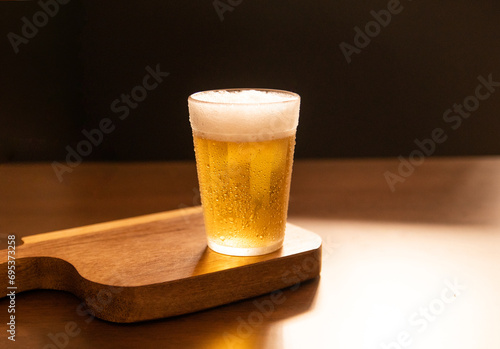 American glass with Beer on wooden table (Traditional Brazilian Cup)