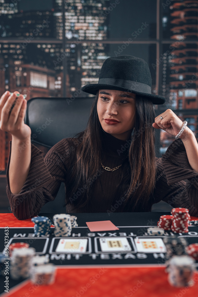 beautiful female playing texas hold'em poker at casino beautiful female playing texas hold'em poker at casino