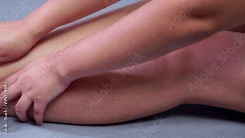 Wallpaper Mural Close-up of an individual trying to give herself a massage by slowly caressing her knees down to her legs in a downward and upward motion. Torontodigital.ca