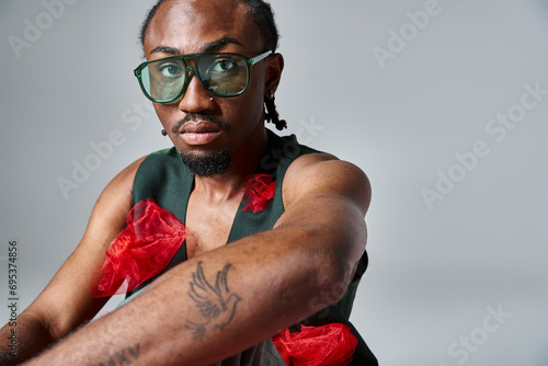 portrait of handsome african american man in vibrant clothes with sunglasses, fashion concept