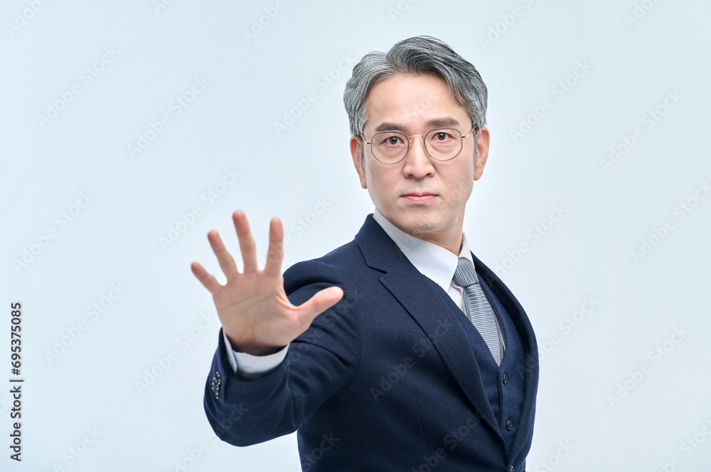 A middle-aged man in a suit expresses various emotions through facial expressions and hand gestures.
