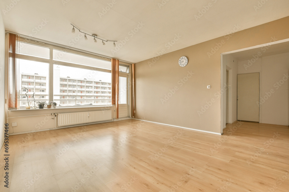 Empty living room with hardwood floor and window Empty living room with hardwood floor and window
