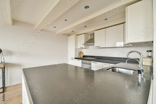 Modern kitchen interior with white cabinets and granite countertop
