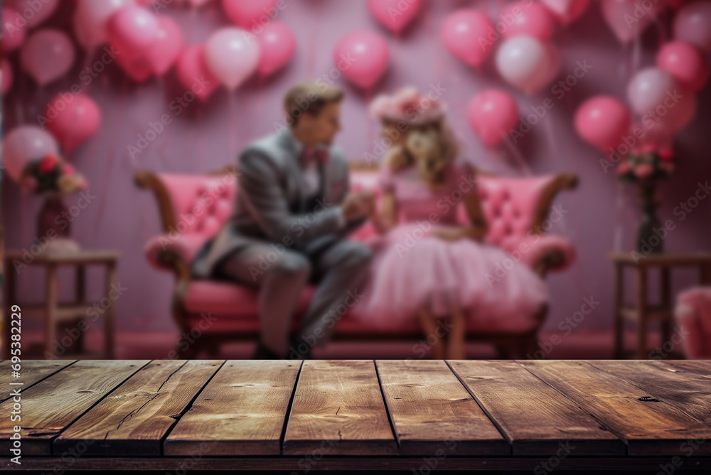 Wooden, empty table with a blurred, romantic background, of couple in romantic embrace and pink hearts. Copy space.