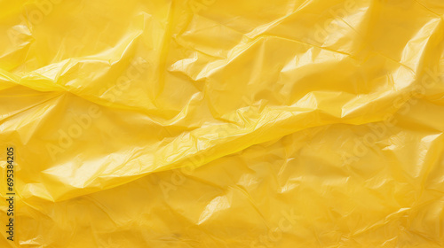 Wrinkled plastic wrap texture on a yellow background. Cellophane package wallpaper
