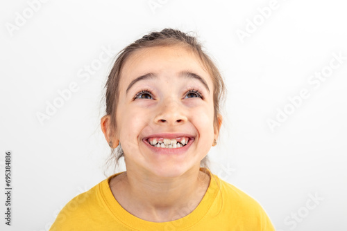 Happy little Caucasian girl smiling on white background isolated, close up.