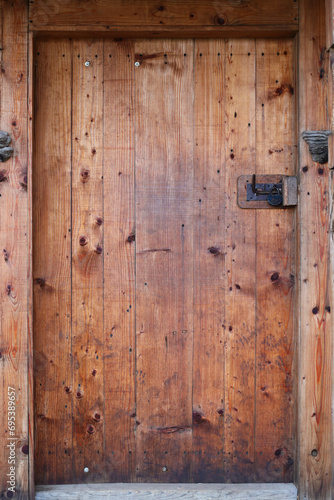 Old small door of rural barn or shed close up texture