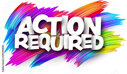 Action required paper word sign with colorful spectrum paint brush strokes over white.