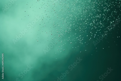  a close up view of water bubbles on a green and blue background with a small amount of bubbles on the bottom of the image 
