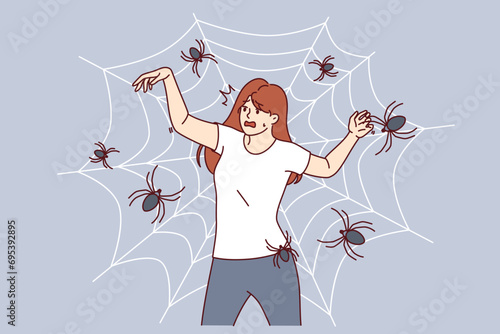Woman with fear of spiders is terrified of being entangled in cobweb and needs treatment for arachnophobia. Girl with arachnophobia screams in fear imagining that she has become victim of insects