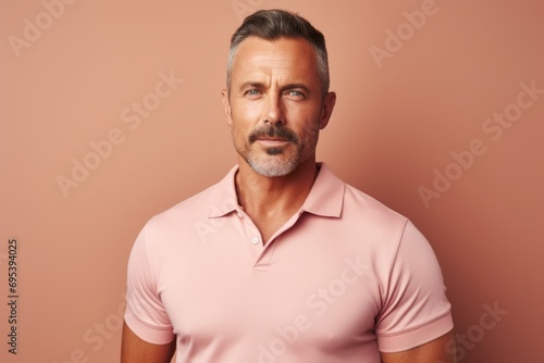 Portrait of a content man in his 40s donning a classy polo shirt against a pastel brown background. AI Generation