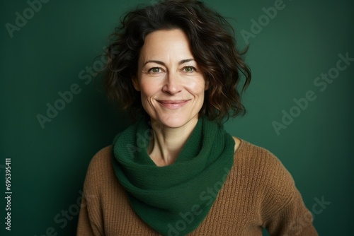 Portrait of a merry woman in her 40s wearing a cozy sweater against a soft green background. AI Generation