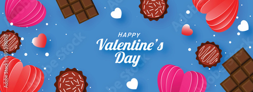 Top View of Chocolate and Paper Cut Hearts Decorated on Blue Background for Happy Valentine's Day.