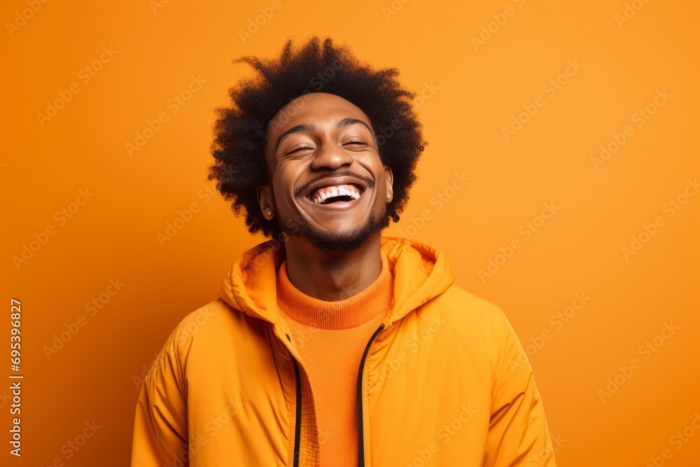 Portrait of a joyful afro-american man in his 20s dressed in a breathable mesh vest against a soft orange background. AI Generation Portrait of a joyful afro-american man in his 20s dressed in a breathable mesh vest against a soft orange background. AI Generation