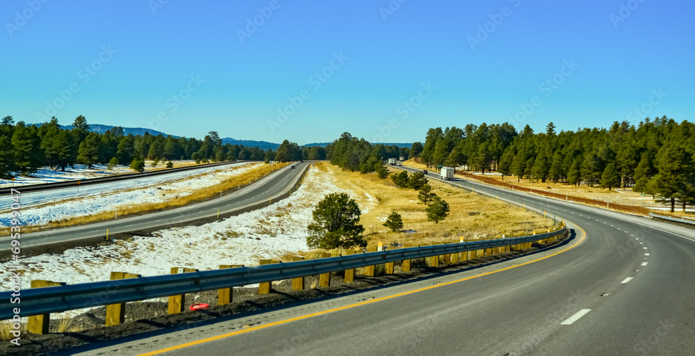 Highway in the foothills overgrown with coniferous forest in winter in Arizona