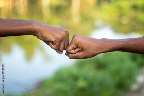 Two human hands are making fists and blurred background