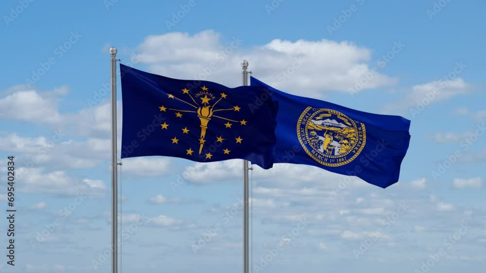 Nebraska and Indiana US state flags waving together on cloudy sky, endless seamless loop Nebraska and Indiana US state flags waving together on cloudy sky, endless seamless loop