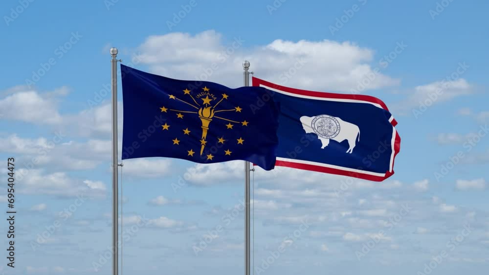 Wyoming and Indiana US state flags waving together on cloudy sky, endless seamless loop Wyoming and Indiana US state flags waving together on cloudy sky, endless seamless loop