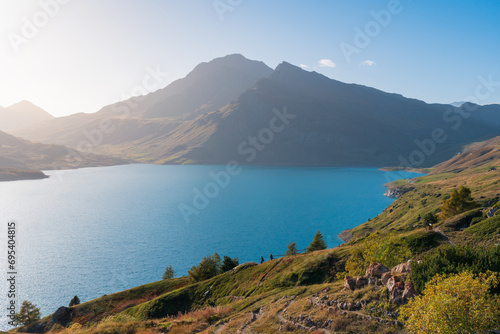 Mont-Cenis (Moncenisio) lake and mountain peak (Val-Cenis), blue sky, soft light, shore and clear water