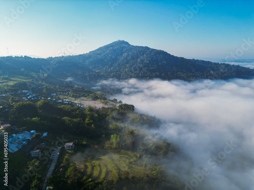 Aerial view of flowing fog waves on mountain tropical rainforest.Khao Kho, Phetchabun, Thailand.