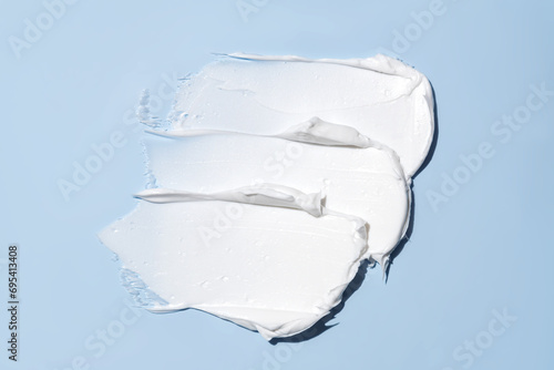 White cream smear on a blue background photo