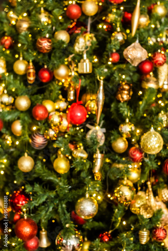 defocus. Christmas, New Year tree. background from gold, yellow, red balls. bokeh, lights