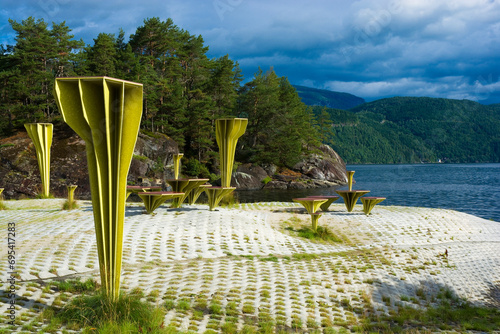 Chairs and tables built from materials from recycled plastic boats on the shore of Sandsfjorden in Ropeid, Norway photo