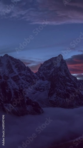 Taboche and Cholatse Mountains at Evening Twilight. Himalaya, Nepal. Timelapse. Vertical Video photo