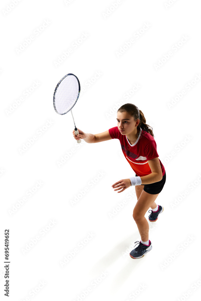 Dynamic movements of professional badminton player practicing with intensity against pristine white background. Concept of sport, active lifestyle, strength and power, action. Copy space.