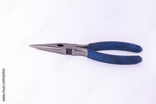 Long nose plier or needle-nose pliers closed with blue rubber handle grip. Side view studio shot isolated on white background macrophotograph. photo