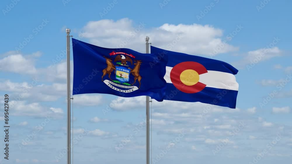 Colorado and Michigan US state flags waving together on cloudy sky, endless seamless loop Colorado and Michigan US state flags waving together on cloudy sky, endless seamless loop