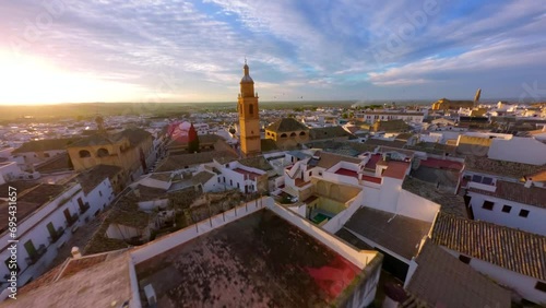 FPV Drone flying at sunset over the church tower in Osuna photo