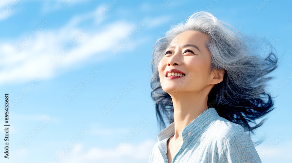 Happy Elderly Japanese Woman with Gray Hair Looks Into the Blue Sky Happy Elderly Japanese Woman with Gray Hair Looks Into the Blue Sky