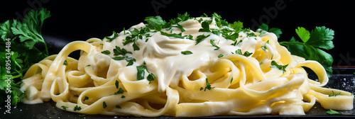 Delicious Italian pasta dish with creamy Alfredo sauce, garnished with parsley and parmesan. photo