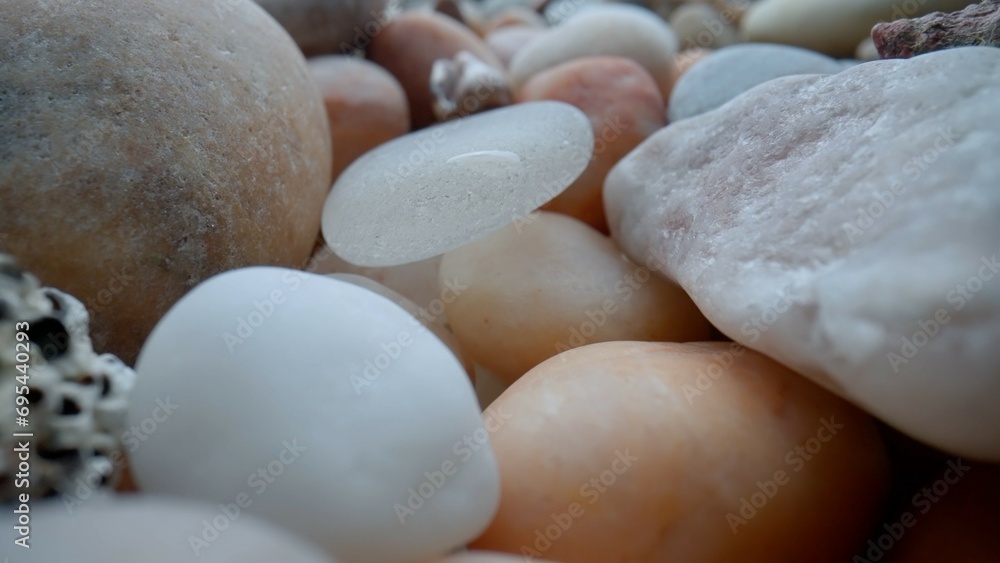 Macro shot of sea bed background. Many beautiful colorful stones pebbles and seashells scattered around. Macro shot of sea bed background. Many beautiful colorful stones pebbles and seashells scattered around.
