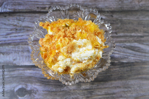 Mango pieces fillings inside Sweet Koshary recipe in Egypt made of multi layers of rice with milk sweet pudding, whipped cream, toasted Konafa and phyllo filo, with some other flavors and fillings photo